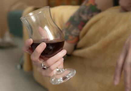 Woman holding glass of red wine