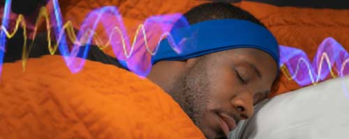 man sleeping listening to binaural beats with SleepPhones headphones