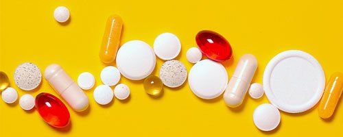 A variety of sleeping pills are displayed on a yellow background.