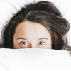 frustrated woman hiding in bed